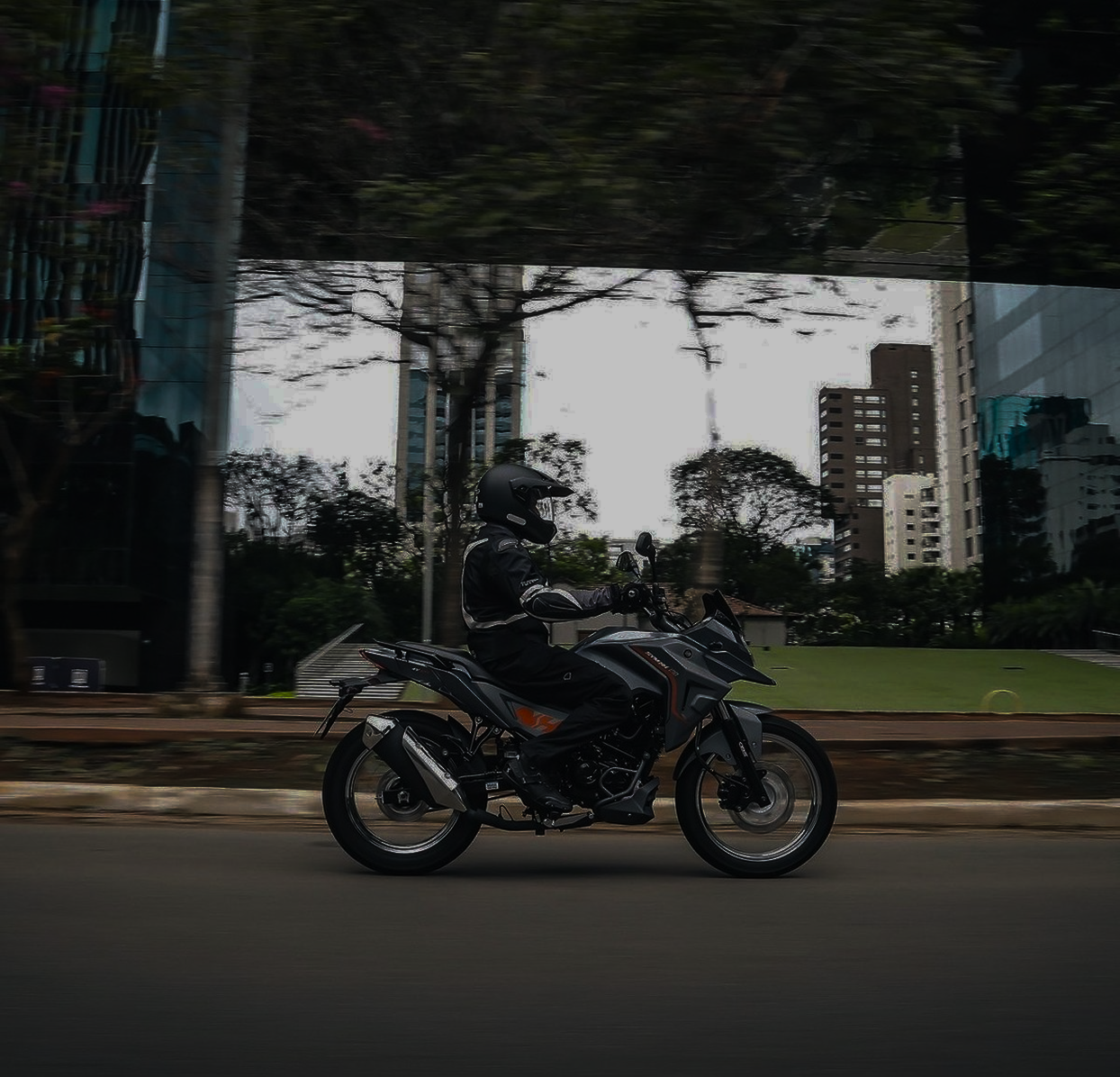 Motociclista pilotando uma motocicleta SYM na cidade